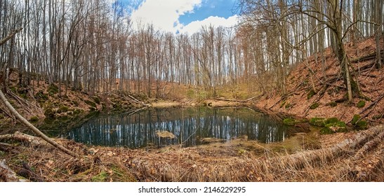 Glacial Lake In The Carpathians. Lake Of Melt Water In The Spring Forest. Blue-green Water From Melted Snow