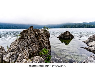 Glacial Mountain Lake With A Rocky Outcrop