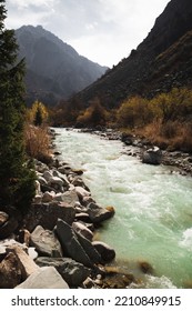 Glacial River Flows Through The Ala Archa Mountain Pass In Kyrgyzstan