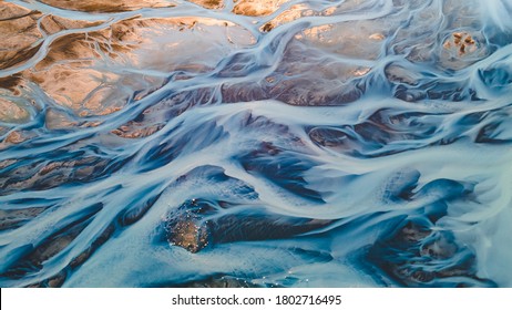 A glacial rivers from above. Aerial photograph of the river streams from Icelandic glaciers. Beautiful art of the Mother nature created in Iceland. Wallpaper background high quality photo - Shutterstock ID 1802716495