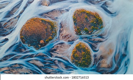 A glacial rivers from above. Aerial photograph of the river streams from Icelandic glaciers. Beautiful art of the Mother nature created in Iceland. Wallpaper background high quality photo - Powered by Shutterstock