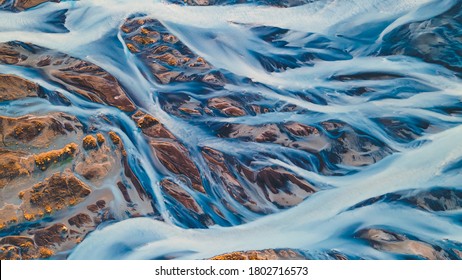 A glacial rivers from above. Aerial photograph of the river streams from Icelandic glaciers. Beautiful art of the Mother nature created in Iceland. Wallpaper background high quality photo