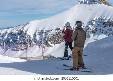 Glacier 3000, Les Diablerets, Switzerland - October 31, 2020: Two People On Skis Standing On Snow.