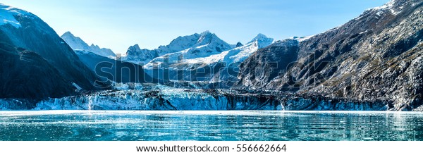 Glacier Bay, Alaska banner landscape from cruise\
ship cruising towards Johns Hopkins Glacier in summer in Alaska,\
USA. Banner panorama\
view.
