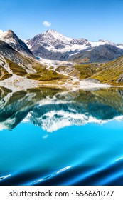 Glacier Bay National Park, Alaska, USA. Amazing Glacial Landscape View From Cruise Ship Vacation Travel Showing Mountain Peaks And Glaciers On Clear Blue Sky Summer Day.