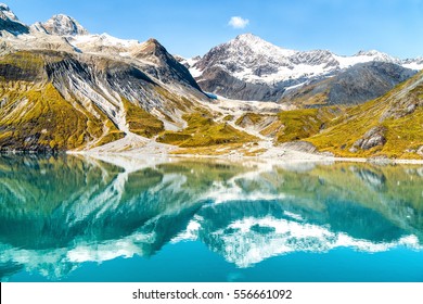 Glacier Bay National Park, Alaska, USA. Amazing Glacial Landscape Showing Mountain Peaks And Glaciers On Clear Blue Sky Summer Day. Mirror Reflection Of Mountains In Still Glacial Waters.