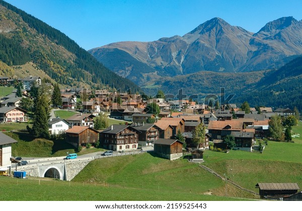 Glacier Express train window scenery,\
idyllic Swiss village                              \
