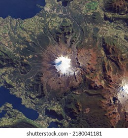 Glacier field covers the upper slopes of Volcano Villarrica in southern Chile’s lake country. Top view of the volcanic mountain with glacier surface. Elements of this image furnished by NASA. - Shutterstock ID 2180041181