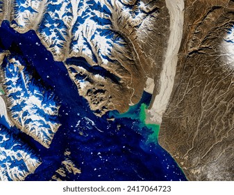 Glacier Flour in Greenland Skies. Satellites captured a rare image of a plume of dusty glacial flour streaming from eastern Greenland. Elements of this image furnished by NASA. - Powered by Shutterstock