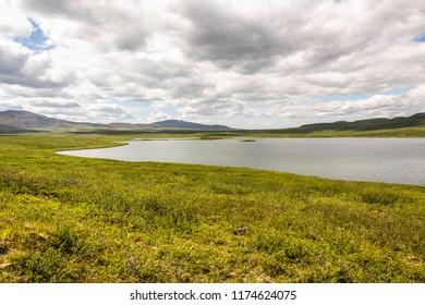 Glacier Gap Lake On A Warm And Sunny Day In The Amphitheater Mountains. Tangle Lakes Archaeological District, Alaska.
