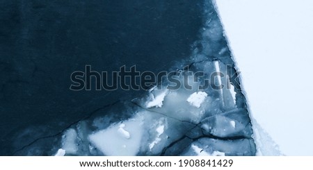 Glacier and iceberg landscape. Ice floes on the water. Ice drift, natural panoramic winter background. Ice surface of the frozen water