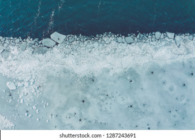 Glacier Lagoon with icebergs from above. Aerial View. Cracked Ice from drone view. Background texture concept. - Powered by Shutterstock