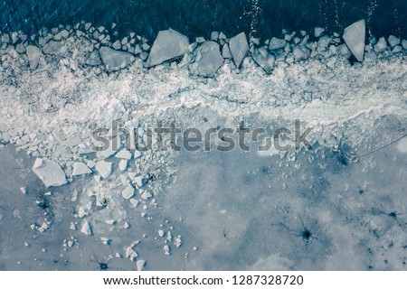 Glacier Lagoon with icebergs from above. Aerial View. Cracked Ice from drone view. Background texture concept.