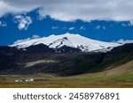 The glacier and volcano Snæfellsjökull towers with its white crown over the outer peninsula of Snæfellsnes in Western Iceland.