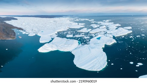 Glaciers drone aerial image from above - climate change and global warming. Glaciers from a melting iceberg in Ilulissat, Greenland. The icy landscape of the Arctic nature in the UNESCO world