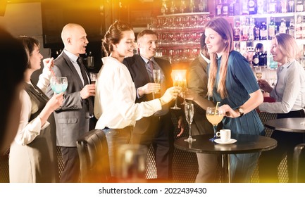 Glad Cheerful Positive Smiling Attractive Women With Cocktails Having Fun With Workmates On Office Party At Nightclub