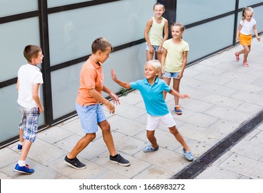 Glad Children In School Age Playing Charades Outdoors