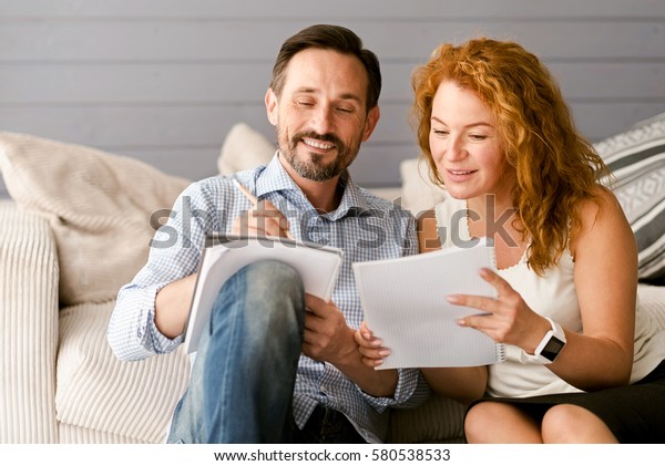 Glad couple
enjoying freelance job at
home