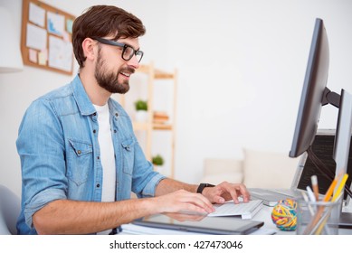 Glad Man Working On Computer