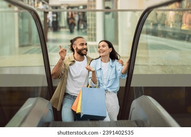 Glad millennial european family shopaholics customers with many packages enjoy walk, customer lifestyle at spare time, fun in mall. Sale, shopping presents together, ad and offer - Powered by Shutterstock