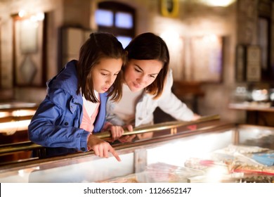 Glad mother and daughter exploring expositions of previous centuries in museum - Powered by Shutterstock