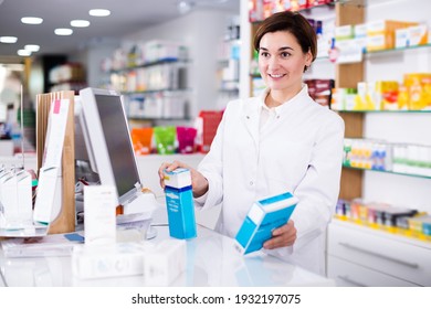 Glad pharmacist ready to assist in choosing at counter in pharmacy