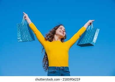 glad teen girl with shopping bags, blue yellow - Shutterstock ID 2185906219