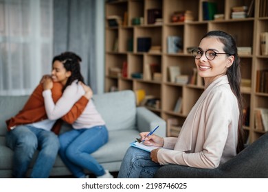 Glad young caucasian male hugging black female at meeting with doctor psychologist in office clinic interior. Family psychological therapy, consultation together, mental treatment and solving problems - Shutterstock ID 2198746025