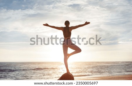 Glad young caucasian woman enjoy workout, freedom, peace and meditation, breathing exercises, practicing yoga on sea beach, back, sun flare. Health care, balance, vitality outdoor