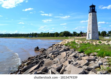 Gladstone Lighthouse in the Upper Peninsula of Michigan on shore of Great Lake Michigan on Green Bay. The waters are visible to horizon.  The Gladstone Michigan Lighthouse stands tall at breakwater. - Shutterstock ID 1815479339