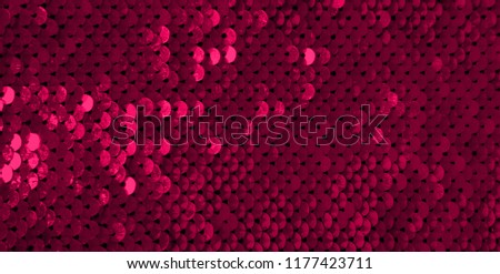 Glamor Red Background with Sequins close-up. Abstract Texture scales with shiny maroon sequins on fabric, macro. Beautiful Holiday Wallpaper with pattern of round Sequins