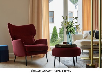 Glamorous living room interior design with modern beige sofa, red armchair and elegant personal accessories. Template. 
