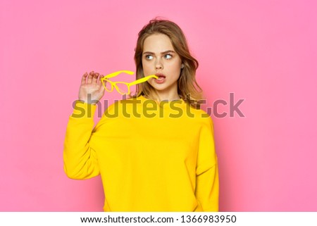 glamorous woman in a yellow sweater series pink background lifestyle model