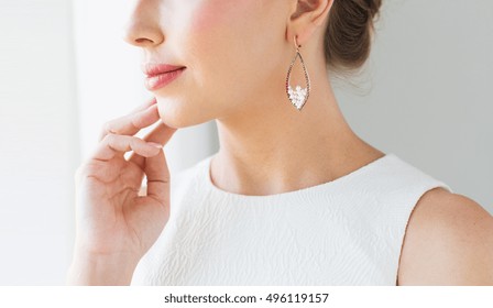 Glamour, Beauty, Jewelry And Luxury Concept - Close Up Of Beautiful Woman Face With Pearl Earring