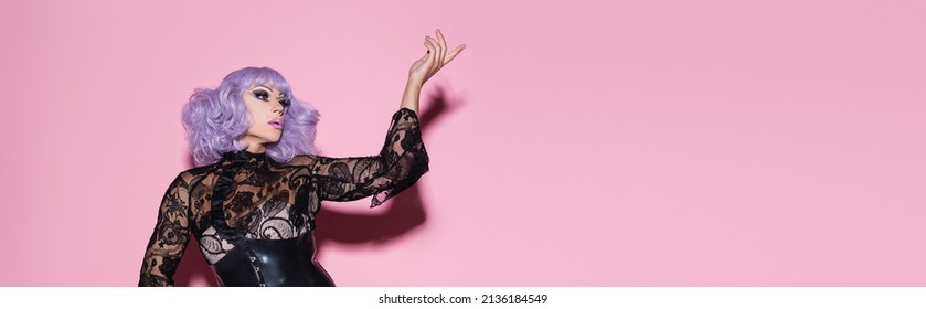glamour drag queen in purple wig pointing with finger on pink, banner - Shutterstock ID 2136184549