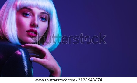 Glamour fashion girl. Beauty face with bright makeup. Young beautiful woman in a white wig, bob hairstyle. Close up art portrait  of  an young attractive woman with vivid colors. Stylish blonde.