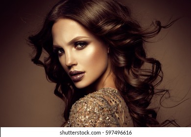 Glamour Portrait Of Beautiful Girl Model With Makeup And Romantic Hairstyle. Fashion Shiny Highlighter On Skin, Sexy Gloss Lips Make-up And Dark Eyebrows.