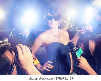 Glamourous Woman Surrounded by Paparazzi