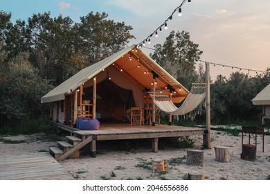 Glamping tent in the forest. Luxury tent sea view. Nature green tourism.