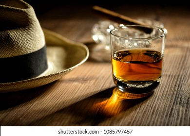 glas of rum, cigar and a panama hat in a bar in Cuba