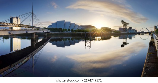 Glasgow Cityscape At Sunrise, Skyline Panorama With Reflecion In River With Sun, Scotland - UK