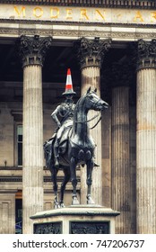 GLASGOW, SCOTLAND - 07 July 2017: Marochetti's Duke of Wellington statue stands outside Glasgow's Museum of Modern Art in Royal Exchange Square with locally added traffic cones.
