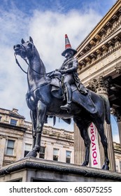 GLASGOW, SCOTLAND - 20 June 2017: Marochetti's Duke of Wellington statue stands outside Glasgow's Museum of Modern Art in Royal Exchange Square with locally added traffic cones.