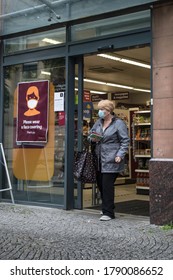 Glasgow / Scotland - August 3, 2020 : Woman Shopper Wearing A Face Mask Leaving A Food Store