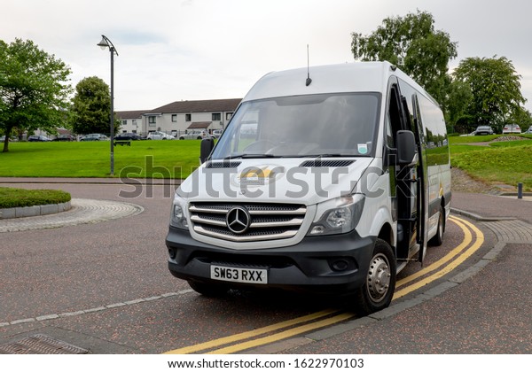 GLASGOW, SCOTLAND - JULY 31, 2019: Mercedes-Benz\
Sprinter touristic shuttle bus of the Escocia Turismo company in\
the Glasgow Green park