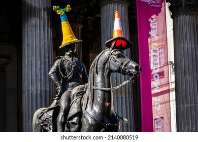 Glasgow, Scotland - March 28th 2022: "Duke of Wellington statue, Gallery of Modern Art, Glasgow, Scotland. Topped with sunflowers and a crochet cover in the colours of the Ukrainian national flag."