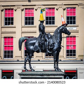 Glasgow, Scotland - March 28th 2022: "Duke of Wellington statue, Gallery of Modern Art, Glasgow, Scotland. Topped with sunflowers and a crochet cover in the colours of the Ukrainian national flag."