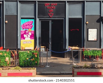 Glasgow, Scotland - March 29th 2022: The Entrance To A Nightclub With A Neon Sign Above Its Door.