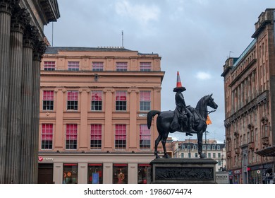 Glasgow, Scotland - October 13, 2020: Duke of Wellington Equestrian Statue with traffic cone on head on Royal Exchange Square outside Glasgow Museum of Modern Art on a cloudy day