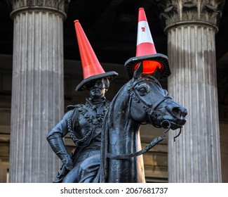Glasgow, Scotland - October 15th 2021: The famous statue of the Duke of Wellington, located on Royal Exchange Square in Glasgow, Scotland. It is typically capped with a traffic cone.